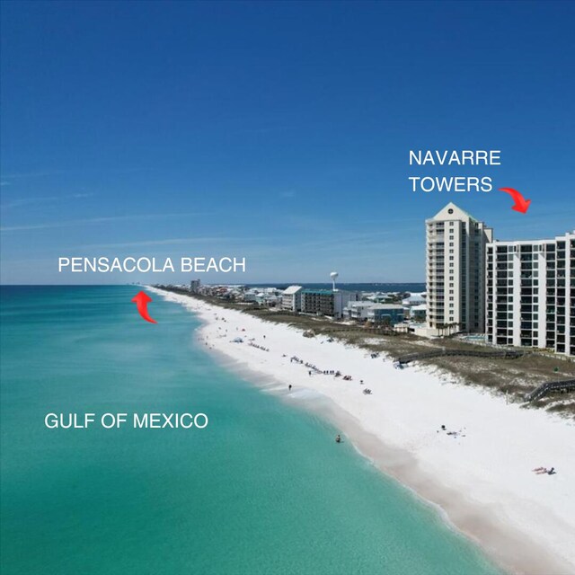 birds eye view of property with a water view and a beach view