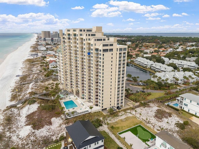 bird's eye view featuring a water view and a beach view