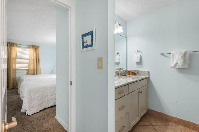 bathroom featuring tile patterned flooring and vanity