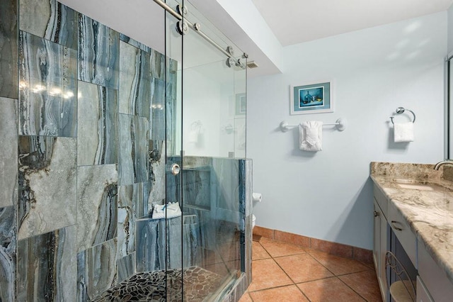 bathroom with tile patterned flooring, vanity, and a shower with shower door