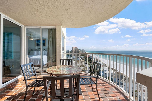 balcony featuring a water view and a beach view