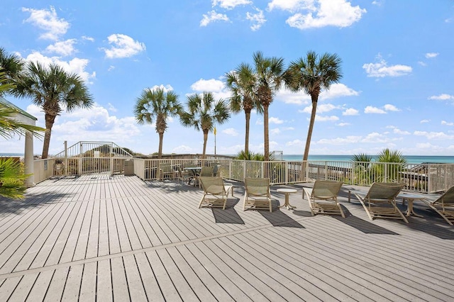 wooden terrace with a water view and a beach view