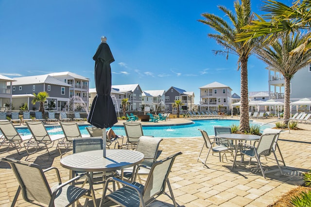 view of pool featuring pool water feature and a patio