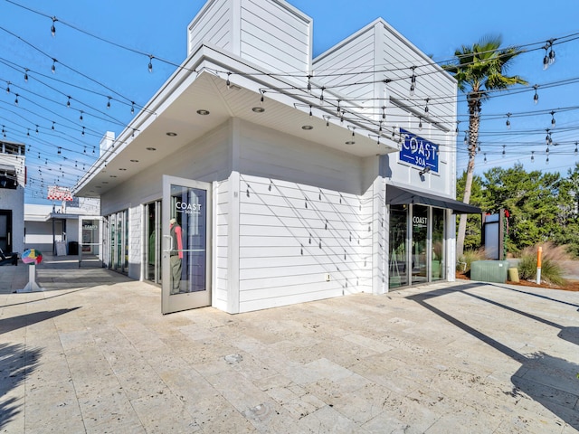 view of side of property featuring a patio area