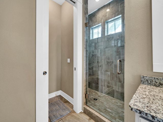 bathroom with tile patterned floors and a shower with door