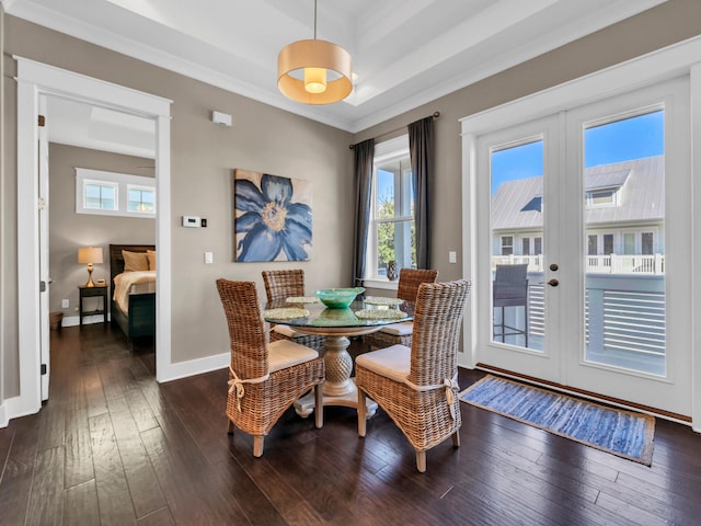 dining area with dark hardwood / wood-style flooring, crown molding, and french doors