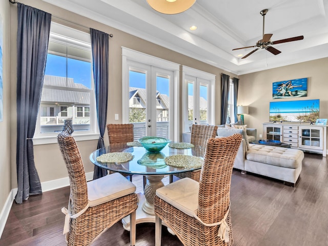 dining space featuring french doors, dark hardwood / wood-style floors, ceiling fan, ornamental molding, and a tray ceiling