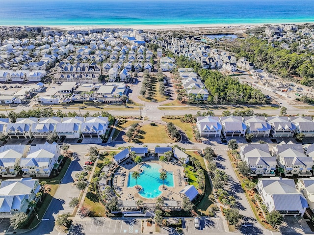 drone / aerial view with a water view and a beach view