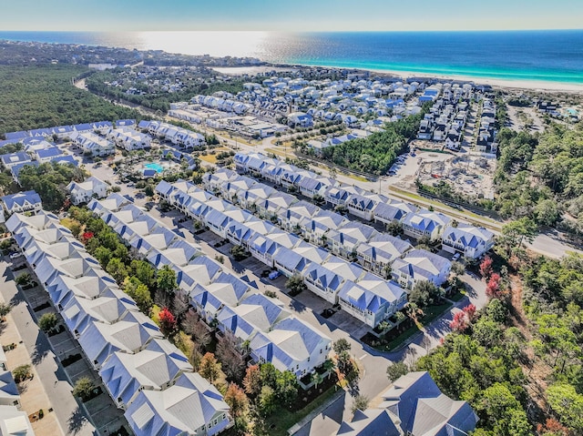 drone / aerial view featuring a water view and a view of the beach