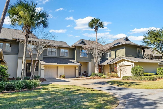 view of front of home featuring a front lawn and a garage