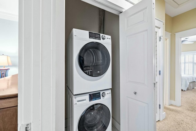 laundry room featuring carpet floors and stacked washing maching and dryer