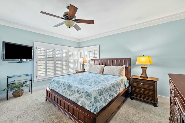 bedroom featuring ceiling fan, ornamental molding, and light carpet