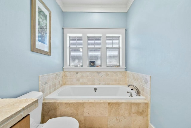 bathroom featuring toilet, ornamental molding, and tiled tub