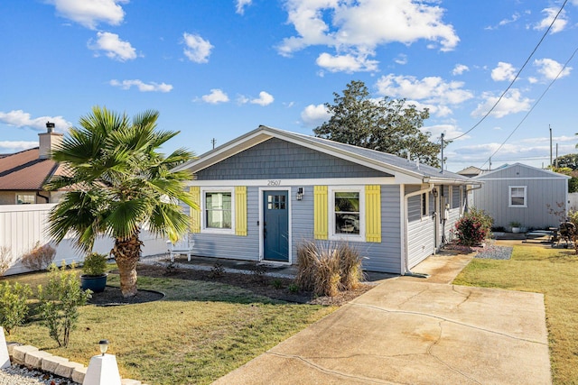 bungalow-style home with fence and a front yard