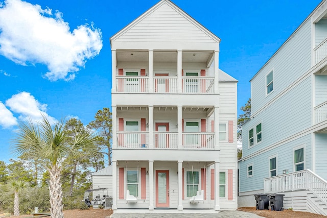 raised beach house featuring a balcony