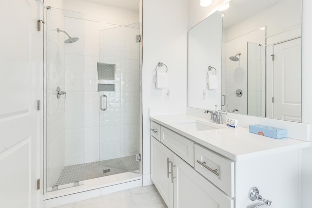 bathroom featuring tile patterned flooring, vanity, and walk in shower