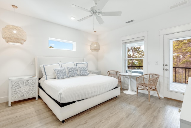 bedroom with access to exterior, multiple windows, light hardwood / wood-style floors, and ceiling fan