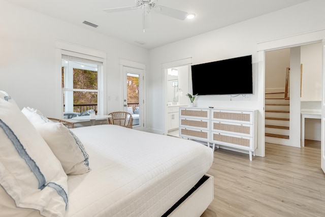 bedroom with light wood-type flooring, ensuite bath, and ceiling fan