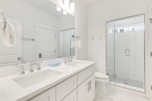 bathroom with vanity, toilet, and a shower with shower door