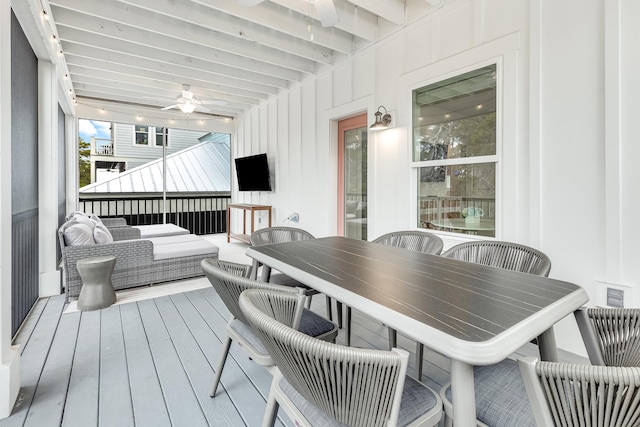 wooden deck with an outdoor living space and ceiling fan