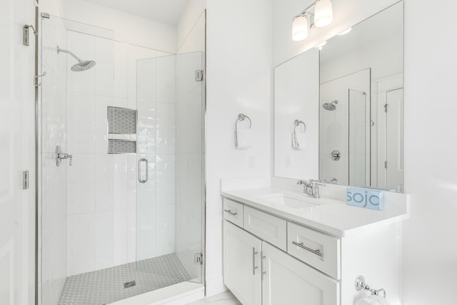 bathroom with vanity and a shower with shower door