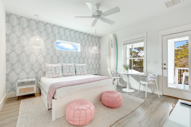 bedroom featuring ceiling fan, access to outside, and light hardwood / wood-style flooring