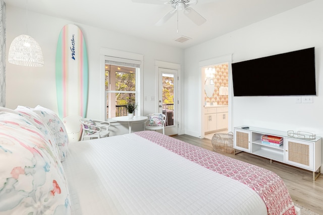 bedroom featuring access to exterior, hardwood / wood-style flooring, and ceiling fan