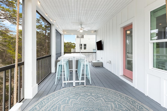 wooden deck featuring ceiling fan