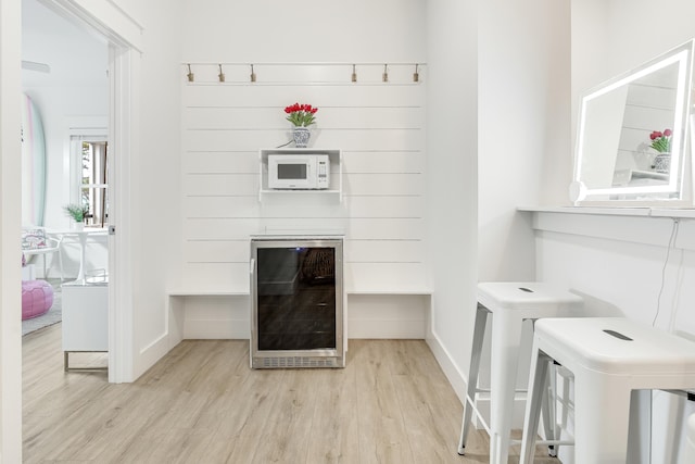 interior space featuring wine cooler and wood-type flooring