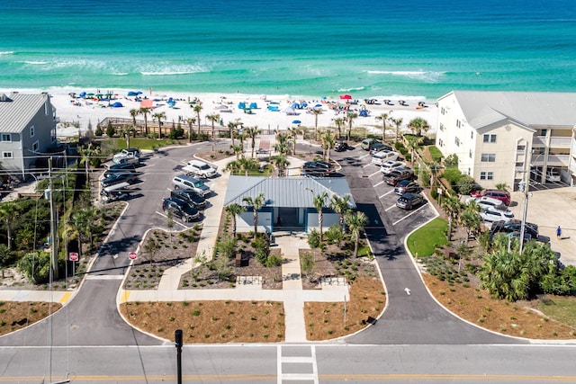 drone / aerial view featuring a water view and a view of the beach