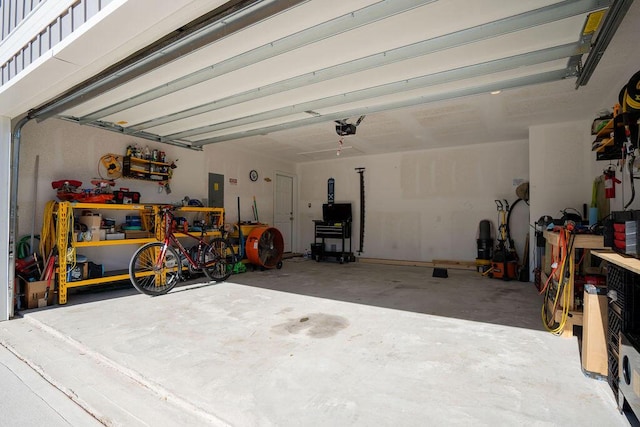 garage featuring electric panel and a garage door opener