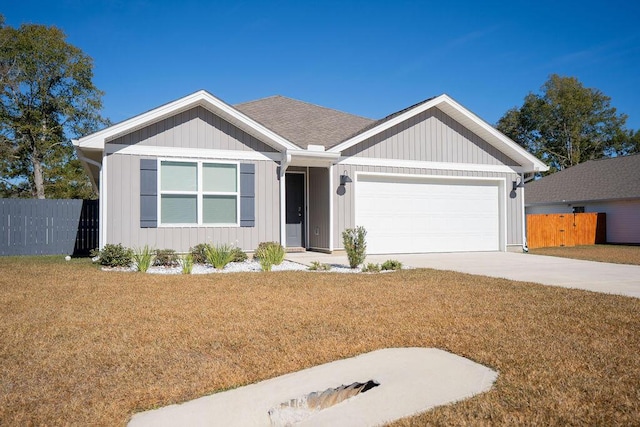 view of front of home featuring a front yard and a garage