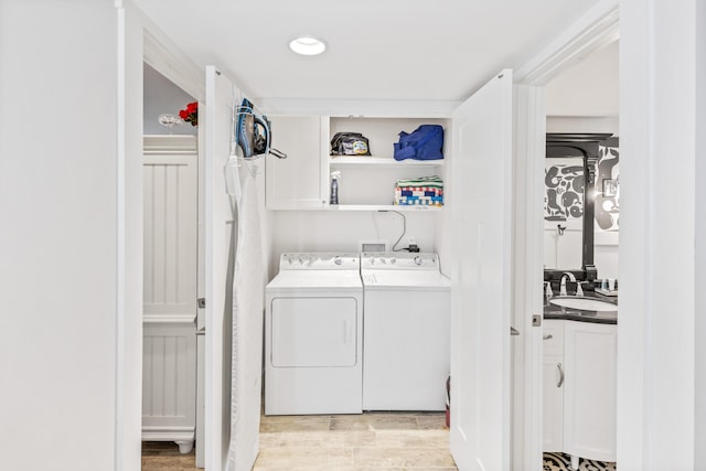 washroom with washer and dryer and sink