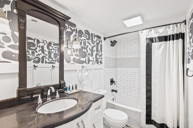 full bathroom featuring shower / bath combo, vanity, and toilet