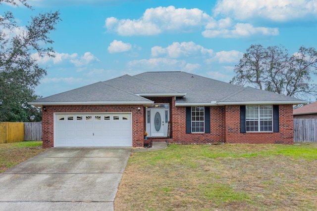 single story home featuring a garage and a front yard