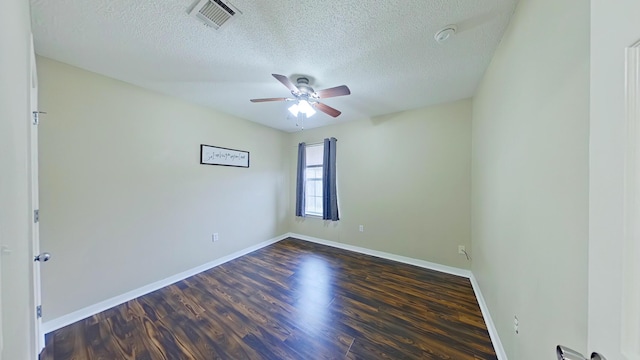 unfurnished room featuring ceiling fan, dark hardwood / wood-style flooring, and a textured ceiling