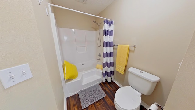 bathroom featuring hardwood / wood-style flooring, toilet, shower / tub combo, and a baseboard heating unit