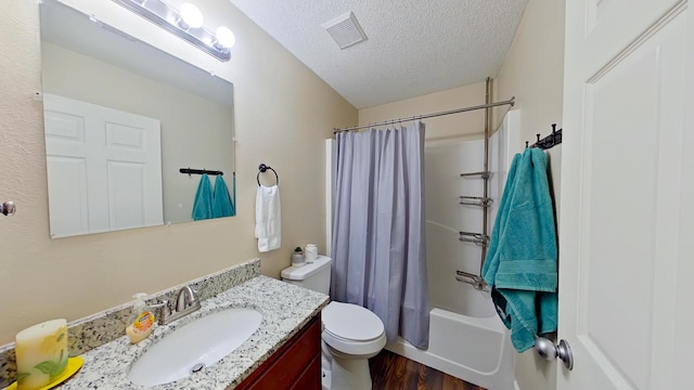 full bathroom with wood-type flooring, a textured ceiling, toilet, vanity, and shower / tub combo