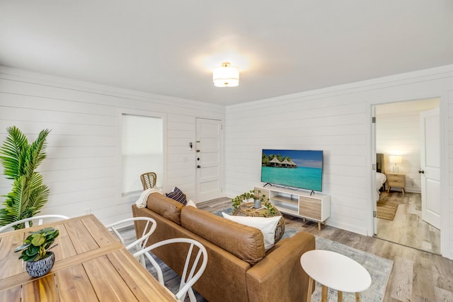 living room featuring hardwood / wood-style flooring and wooden walls