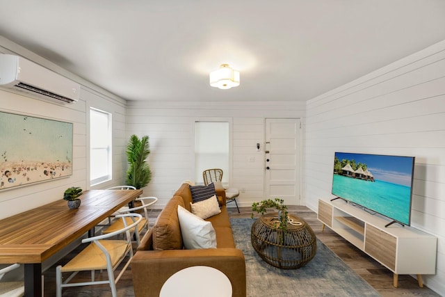 living room featuring a wall unit AC, dark wood-type flooring, and wood walls