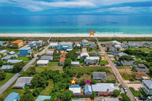 birds eye view of property featuring a water view and a view of the beach