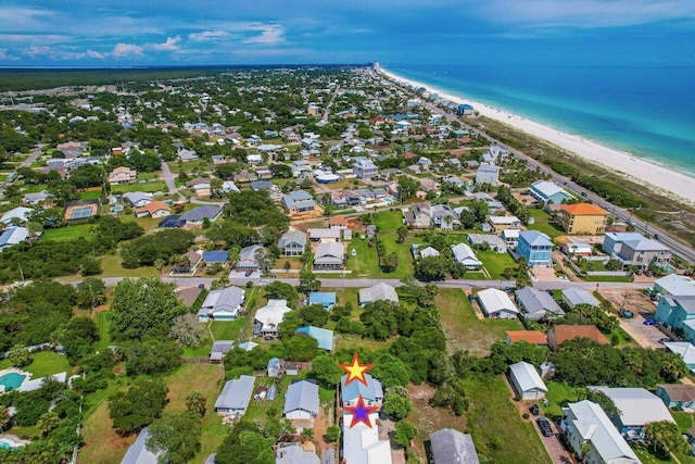 birds eye view of property with a view of the beach and a water view