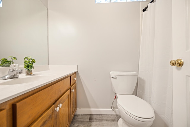 bathroom with hardwood / wood-style floors, vanity, and toilet