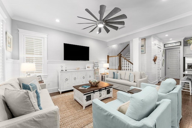 living room featuring hardwood / wood-style flooring, ceiling fan, and crown molding