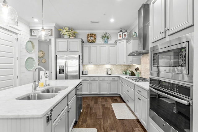 kitchen featuring appliances with stainless steel finishes, wall chimney exhaust hood, decorative backsplash, sink, and crown molding