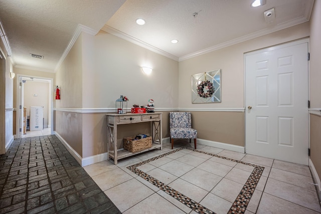 hallway featuring a textured ceiling, light tile patterned floors, and ornamental molding