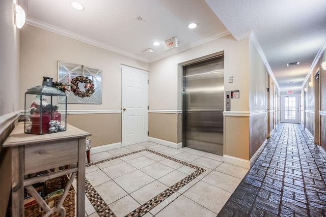 hall with light tile patterned flooring, crown molding, and elevator