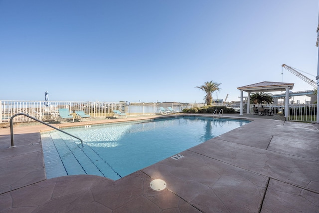 view of swimming pool with a gazebo, a water view, and a patio