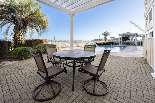 view of patio featuring a pergola, a water view, and a fenced in pool