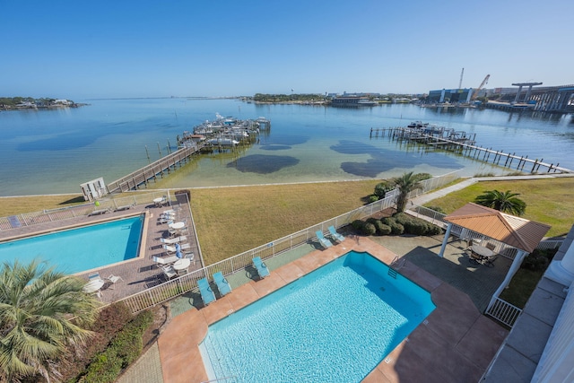 view of pool featuring a dock, a gazebo, a water view, a patio area, and a lawn